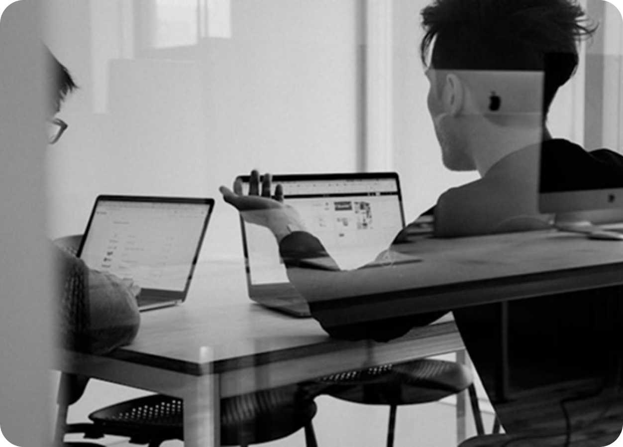 Developer working at a laptop in a team setting